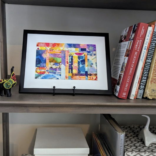 Framed art on bookcase.