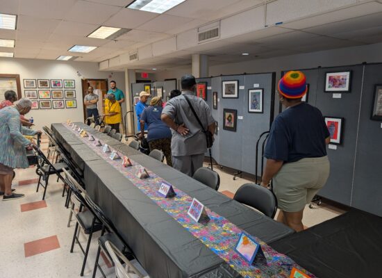 Older adult participants walking and viewing the art gallery.