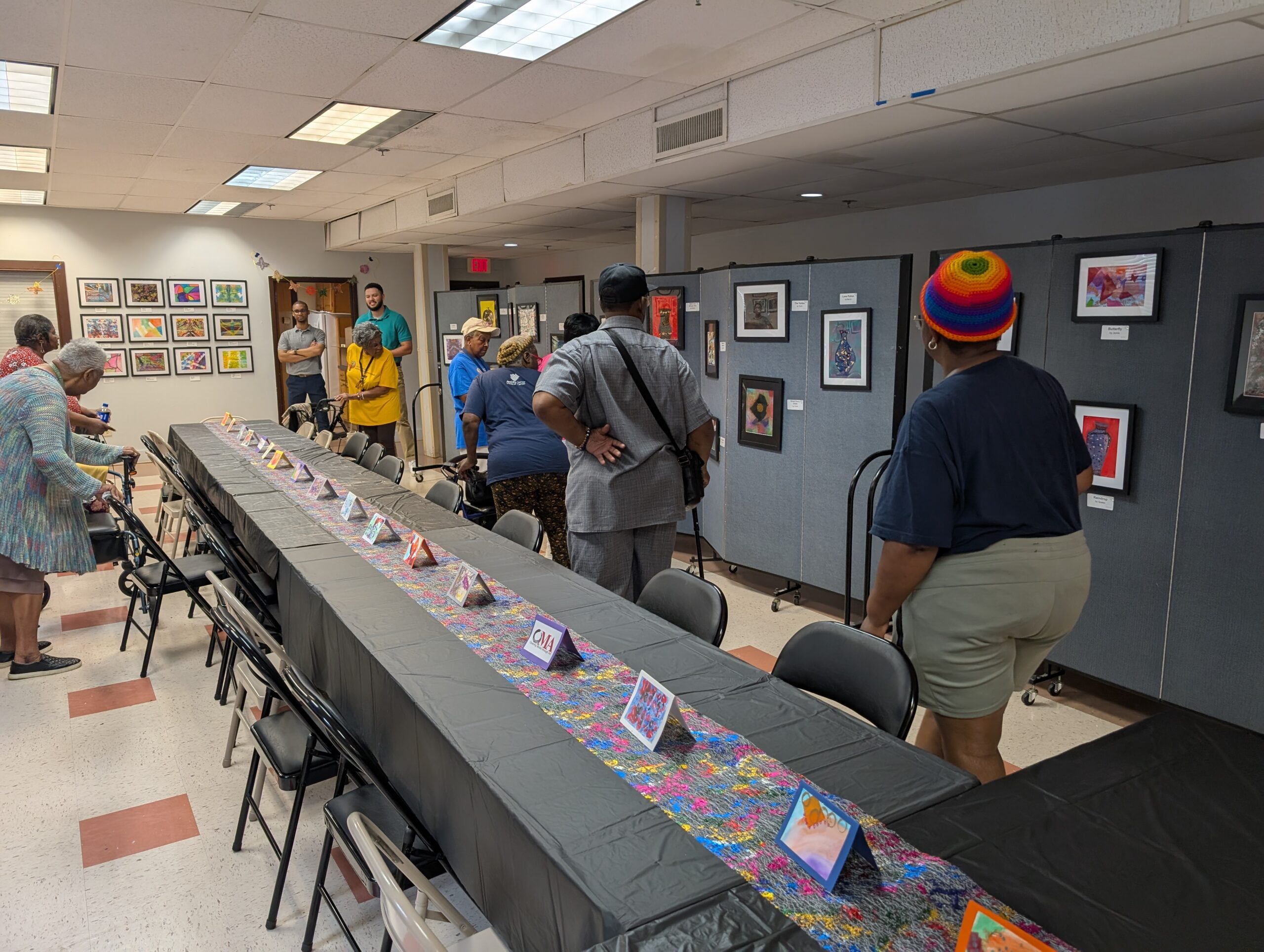 Older adult participants walking and viewing the art gallery.