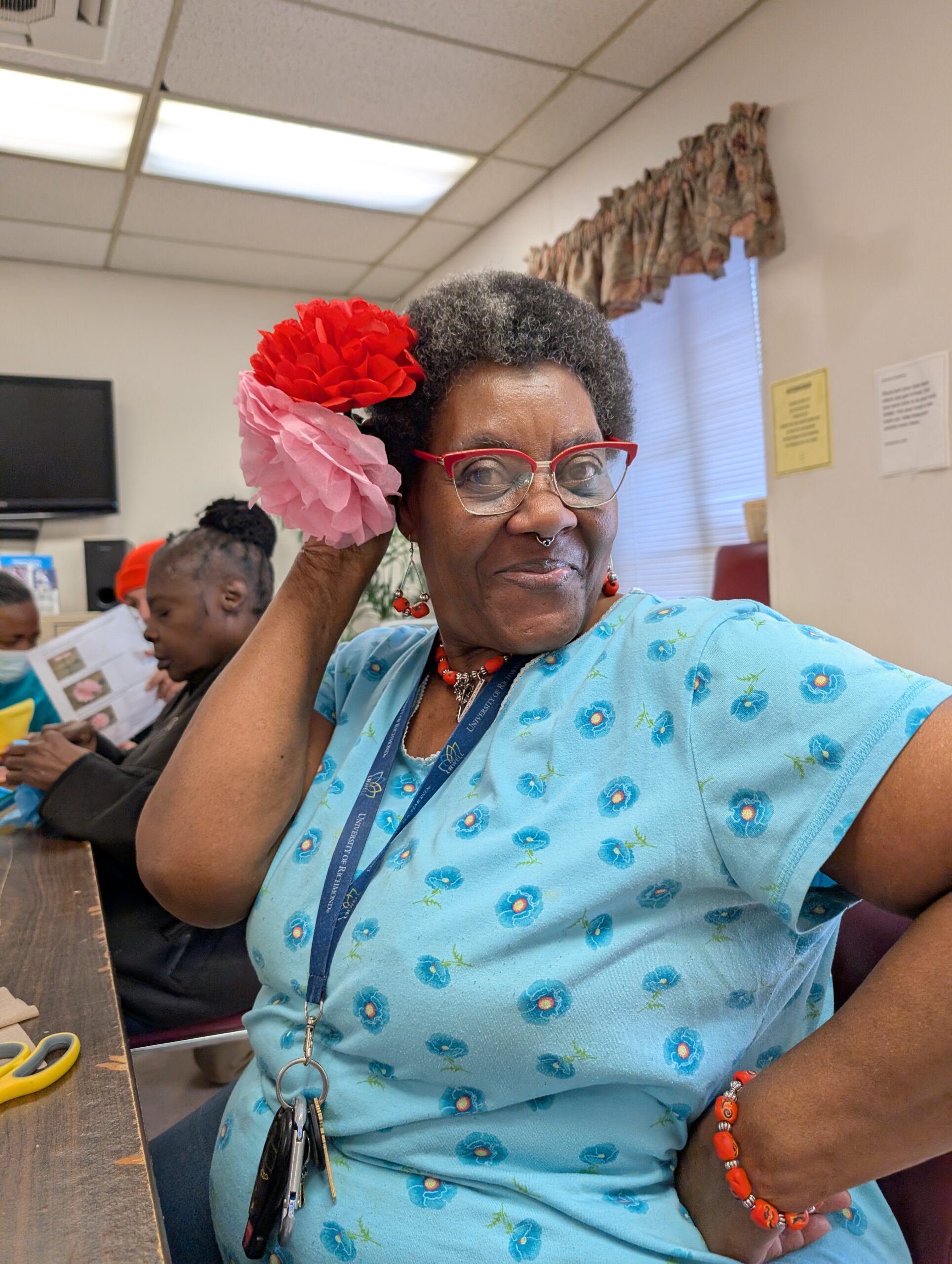 Older lady participant shows off her handmade flower head piece.