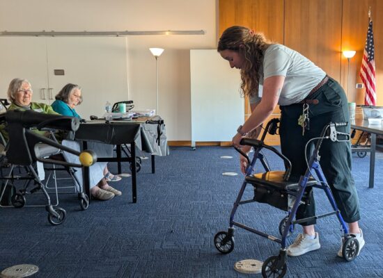 Volunteer demonstrating how to repair a rollator.