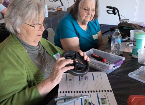 Two older adult participants learning how to repair a rollator.
